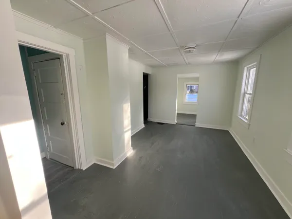 a view of empty room with window and stairs