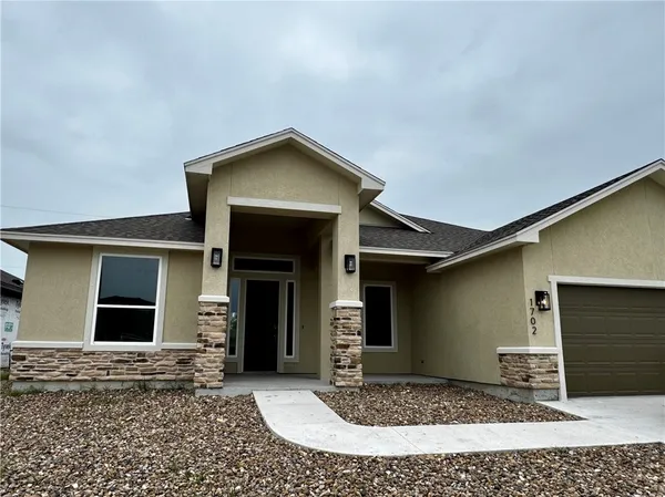 a front view of a house with yard