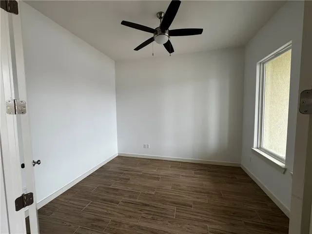 a view of room with window and wooden floor