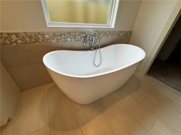 a white bath tub sitting in a bathroom