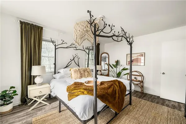 a bedroom with furniture and a window