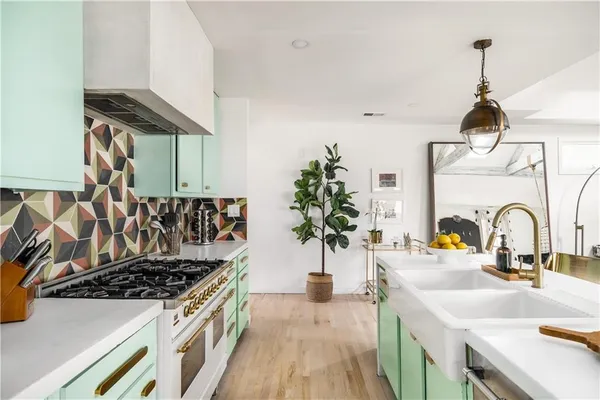 a kitchen with a sink and stove