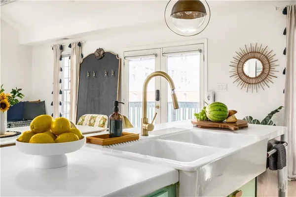 a living room with couches and a chandelier