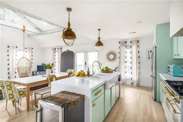a kitchen with stainless steel appliances granite countertop a stove and a wooden floors