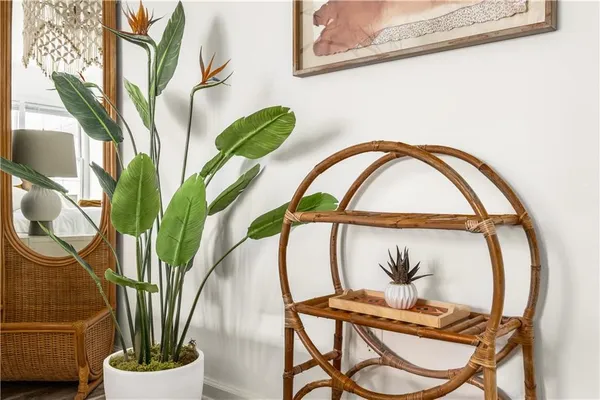 a vase of flowers sitting on a table with a window
