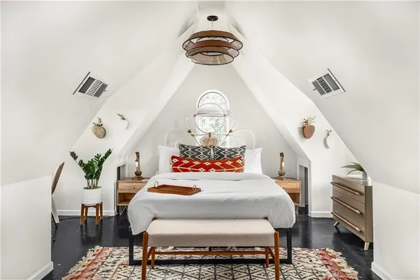 a bedroom with furniture and a chandelier