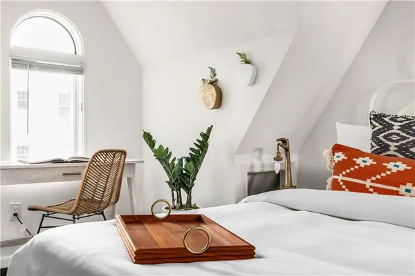 a bedroom with a bed and chair