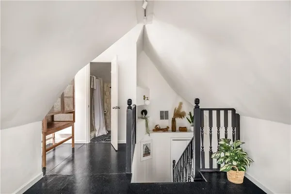 a view of entryway and hall with wooden floor