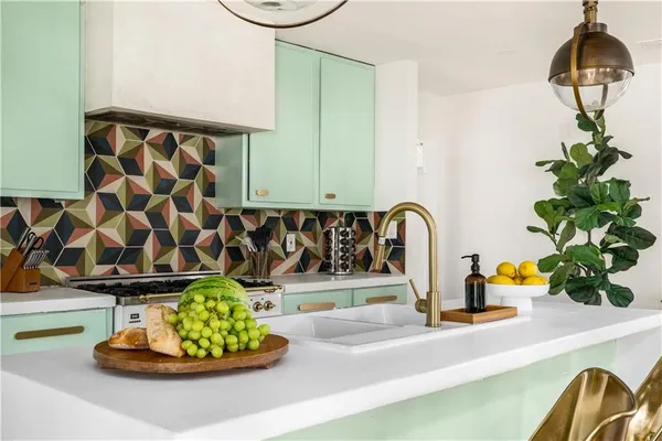a kitchen with a sink and a potted plant