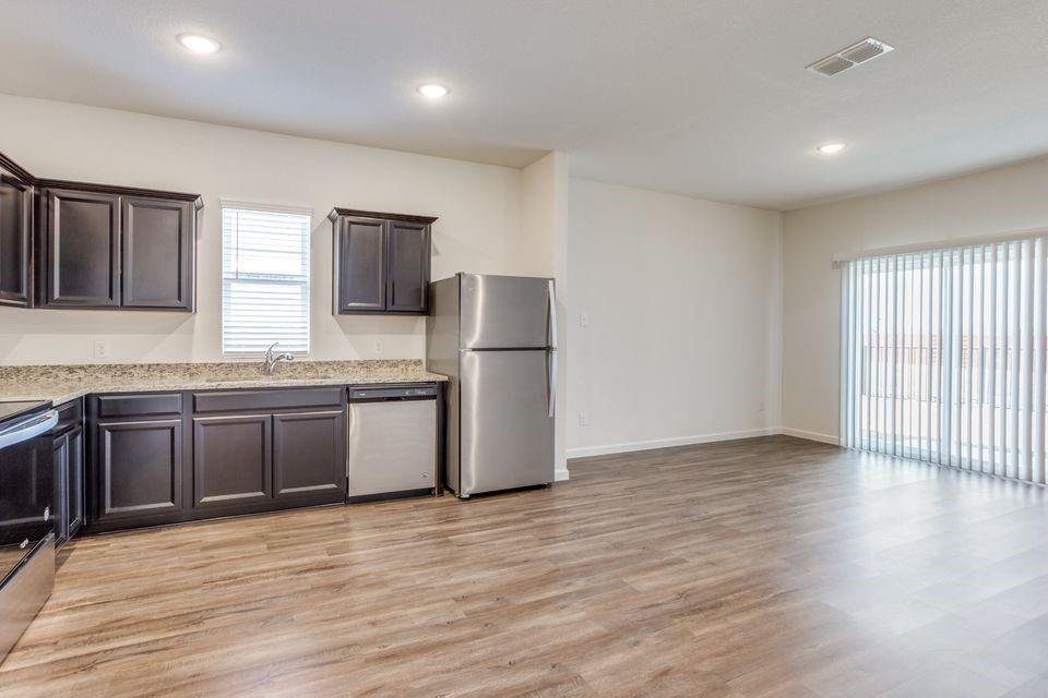 1908 Briar Cove Anna, TX 75409 - Photo 5 of 10 a kitchen with stainless steel appliances granite countertop a refrigerator and a stove top oven