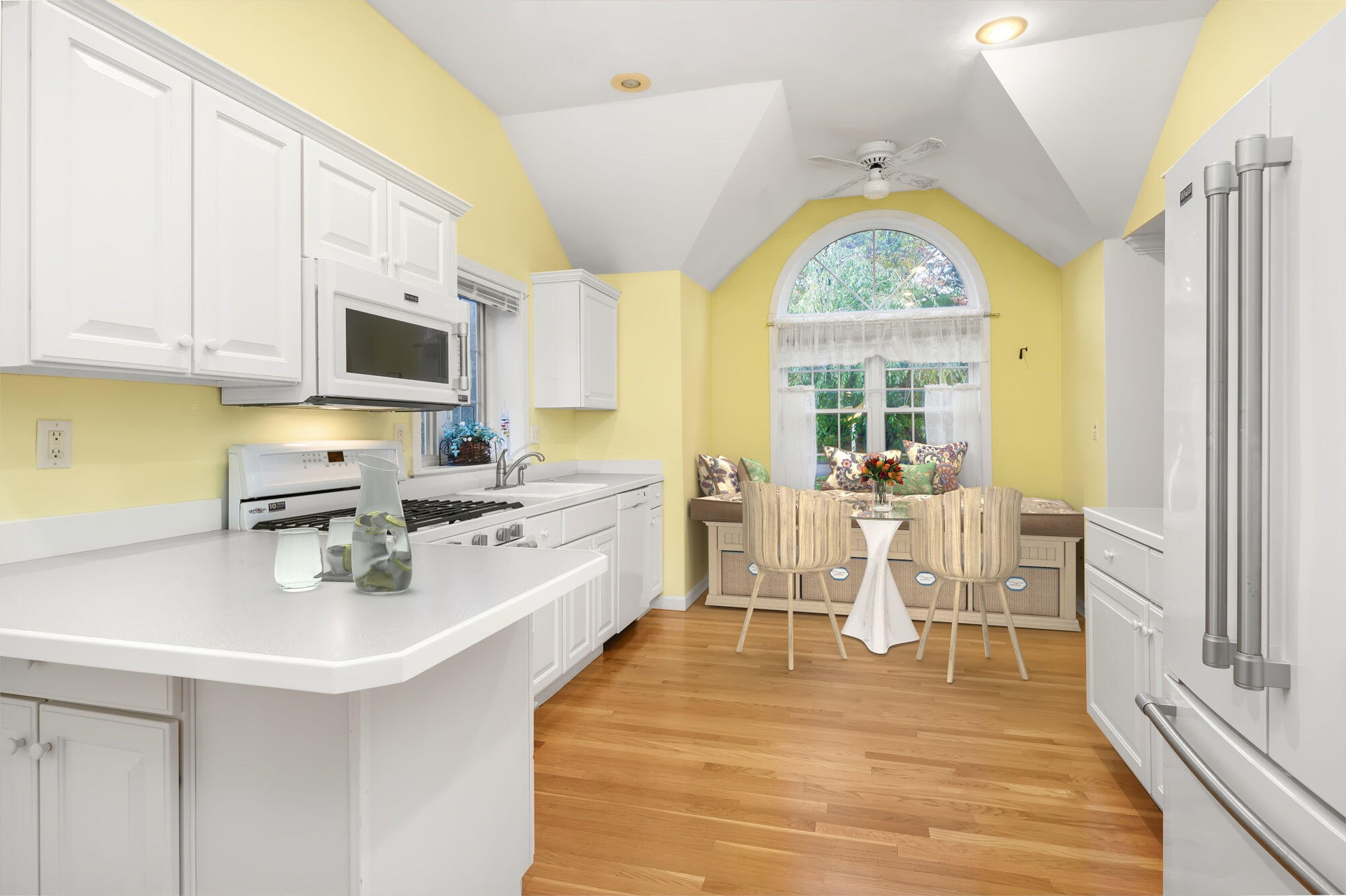105 Snead Drive Mashpee, MA 02649 - Photo 11 of 35 a kitchen with stainless steel appliances a white table chairs and a large window
