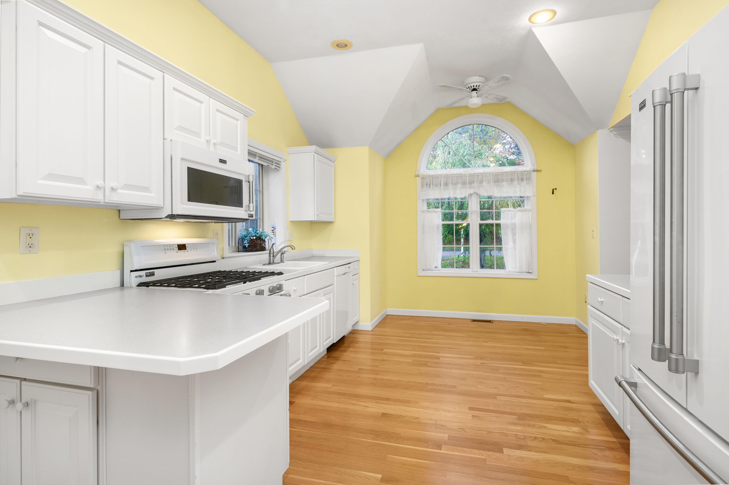 105 Snead Drive Mashpee, MA 02649 - Photo 13 of 35 a kitchen with stainless steel appliances a stove a sink a microwave and cabinets