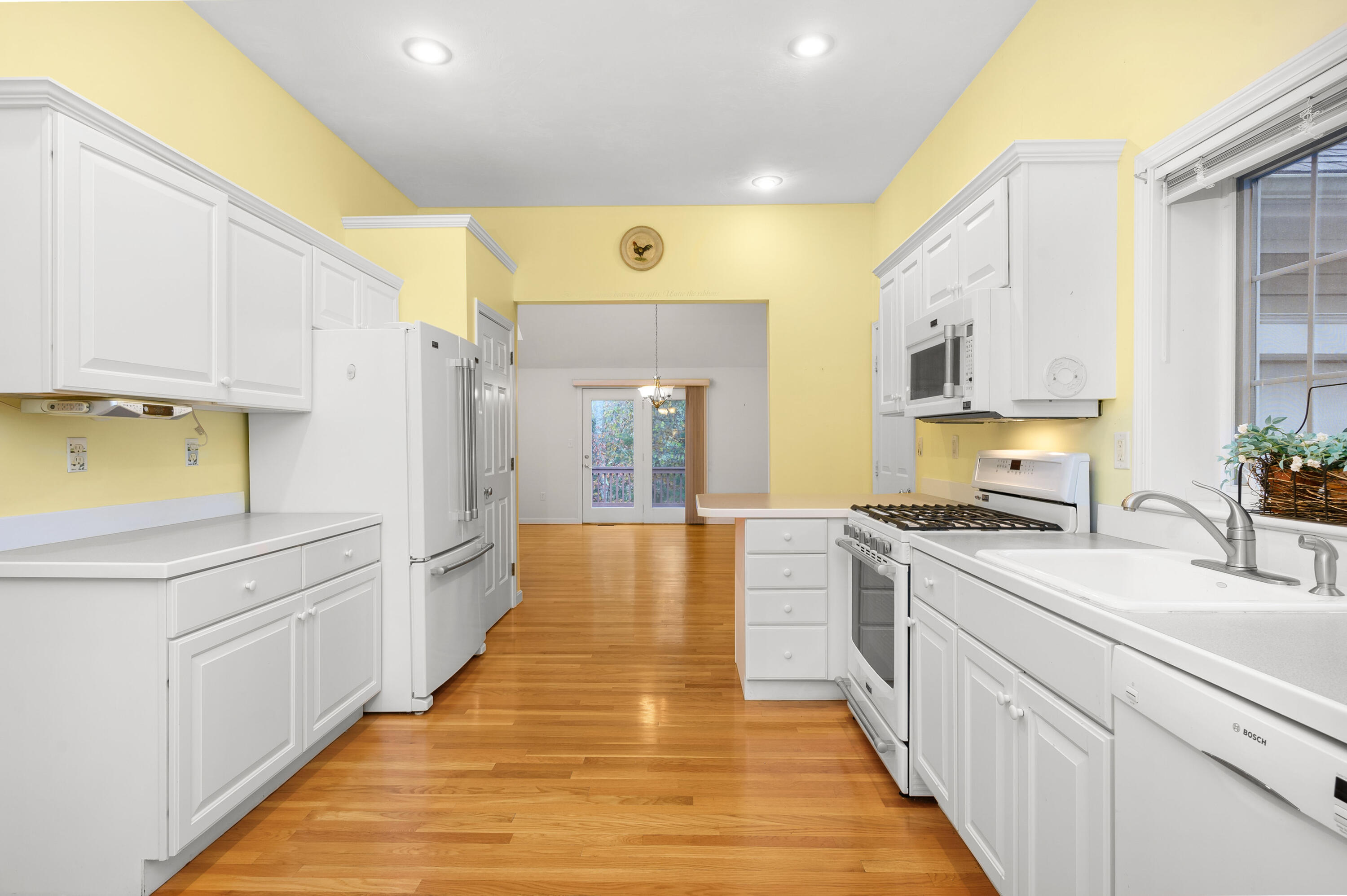 105 Snead Drive Mashpee, MA 02649 - Photo 14 of 35 a large kitchen with stainless steel appliances granite countertop a lot of counter space and wooden floors