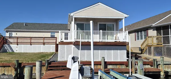 a view of a house with wooden deck