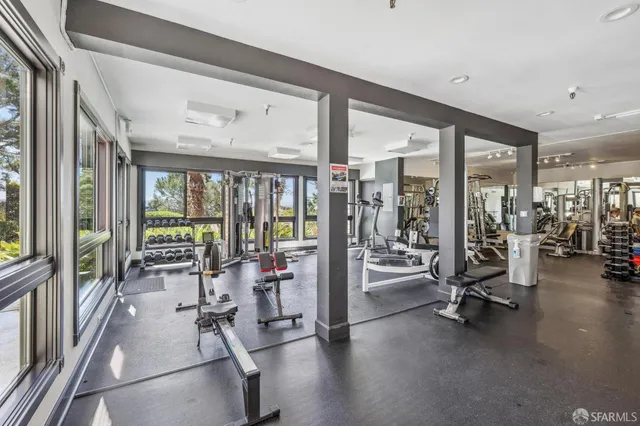 a bedroom with furniture and a large window