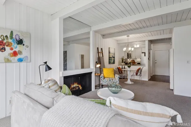 a living room with furniture and a dining table