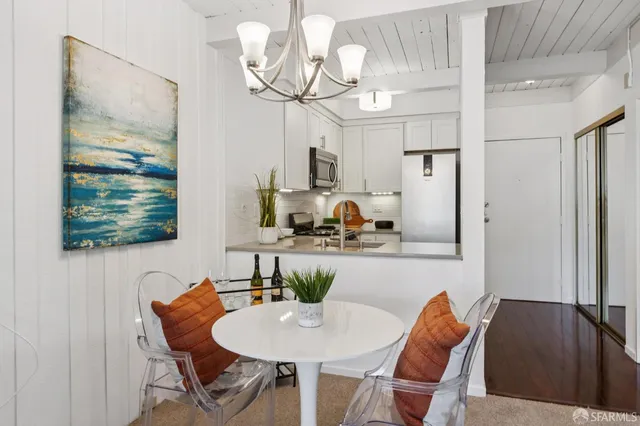 a kitchen with stainless steel appliances granite countertop a refrigerator a stove a microwave a sink and dishwasher