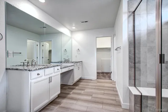 a bathroom with a granite countertop sink mirror and double