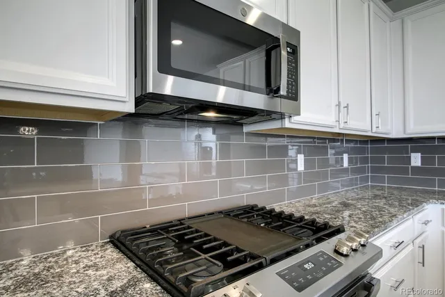 a stove top oven sitting inside of a kitchen