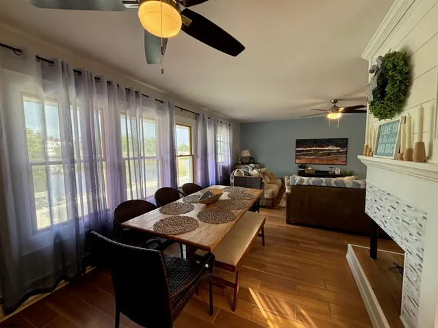 a view of a dining room with furniture window and wooden floor