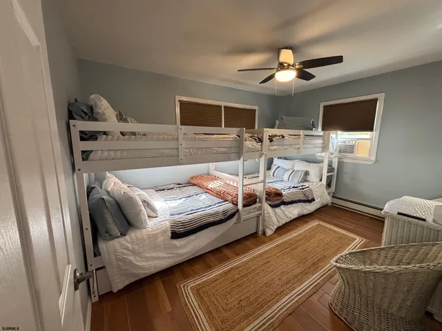 a living room with furniture and a ceiling fan