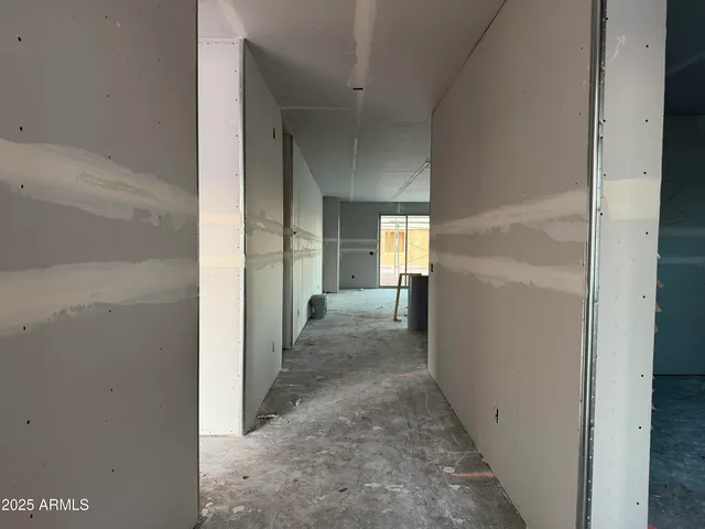 a view of a hallway with a livingroom and a bathroom