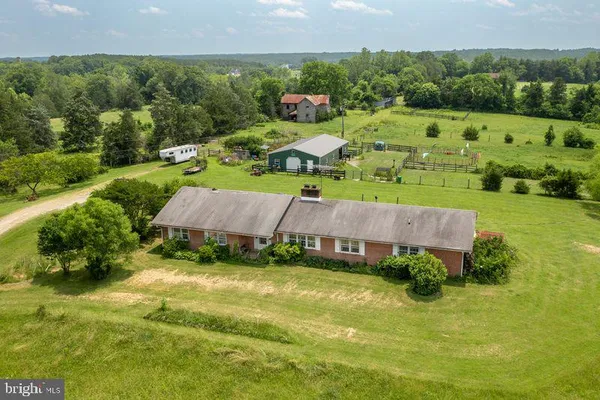 an aerial view of a house with garden space and street view