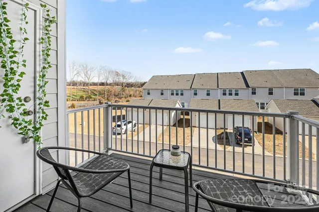 a view of a balcony with wooden fence and floor