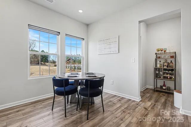a view of a dining room with furniture and windows