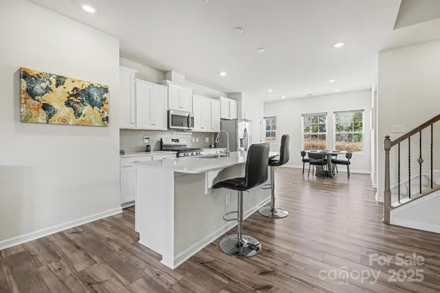 a living room with kitchen island furniture and a wooden floor