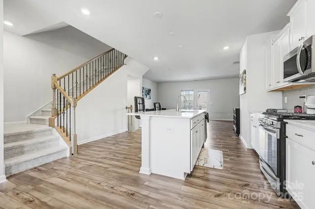 a kitchen with cabinets and wooden floor