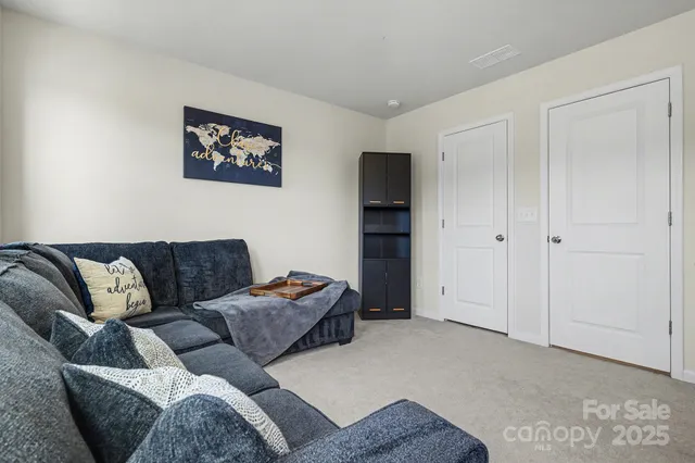 a living room with furniture and a walk in closet