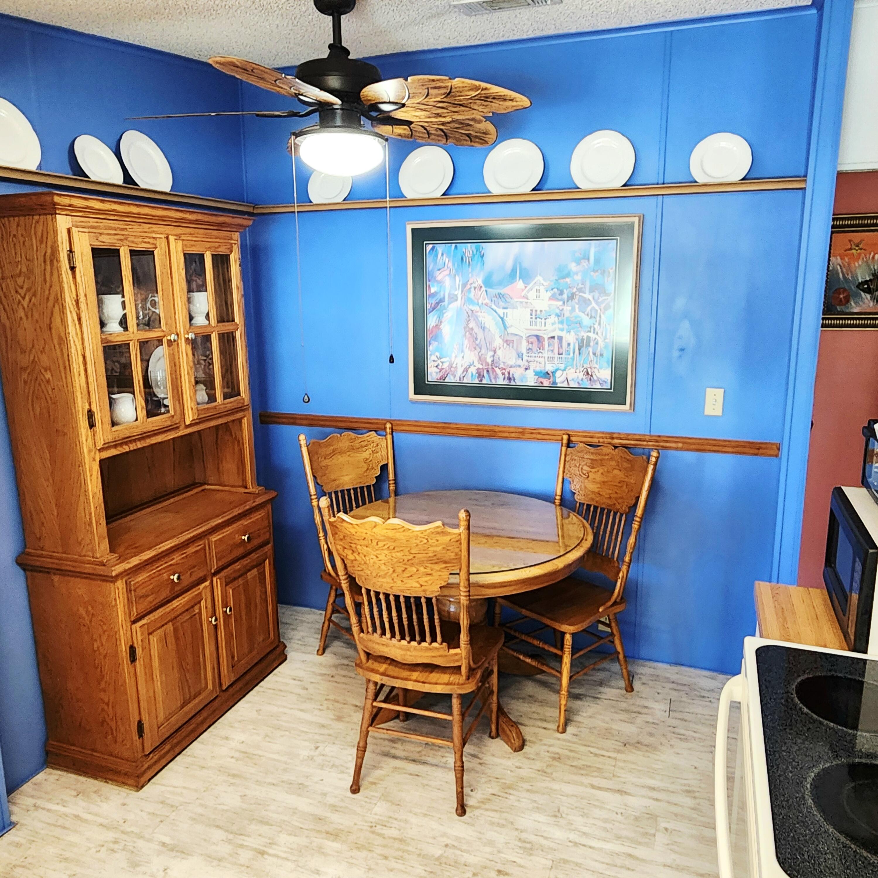 526 Hemingway Terrace, Unit F02 Fort Pierce, FL 34982 - Photo 11 of 55 a view of a dining room with furniture wooden floor and chandelier