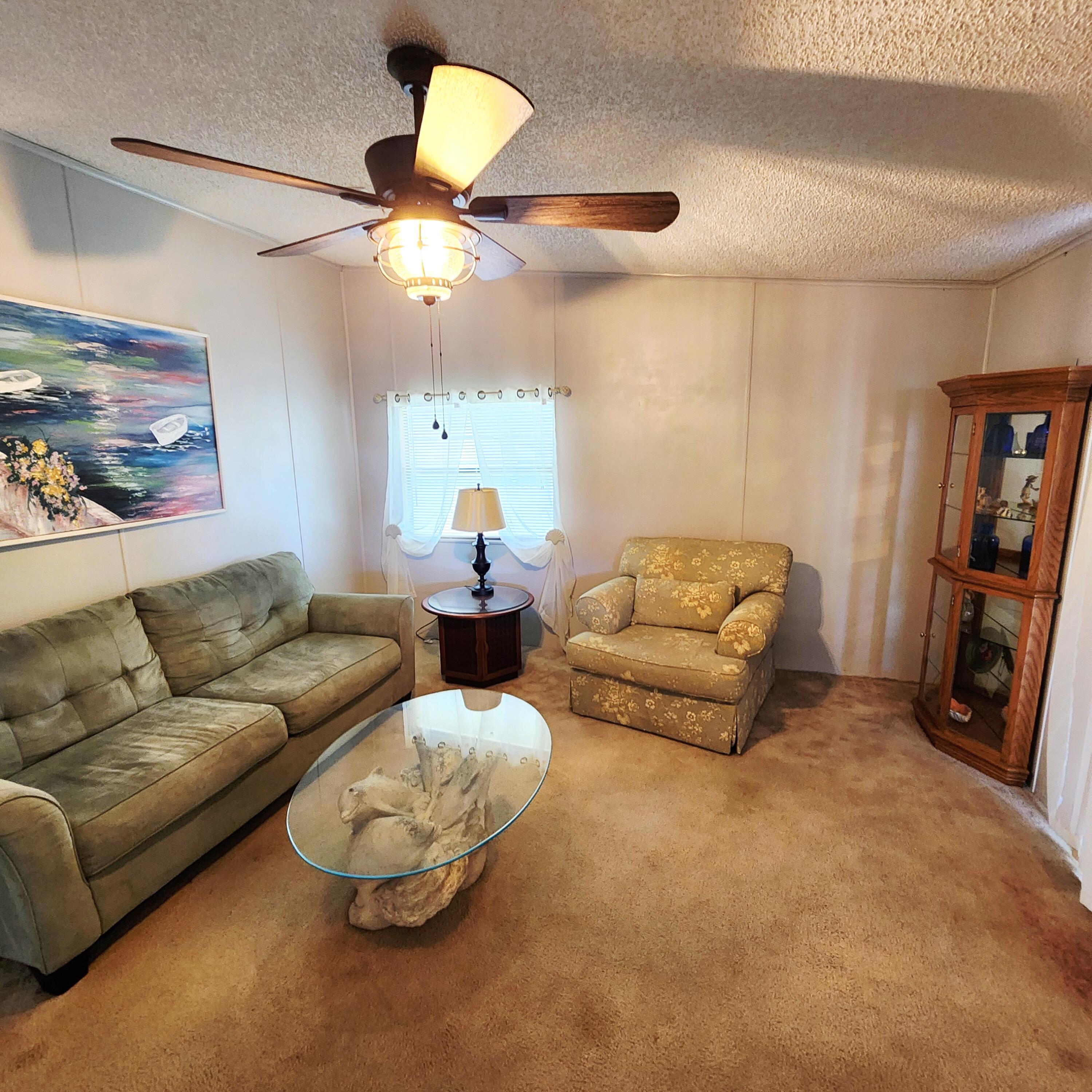 526 Hemingway Terrace, Unit F02 Fort Pierce, FL 34982 - Photo 16 of 55 a living room with furniture and a flat screen tv