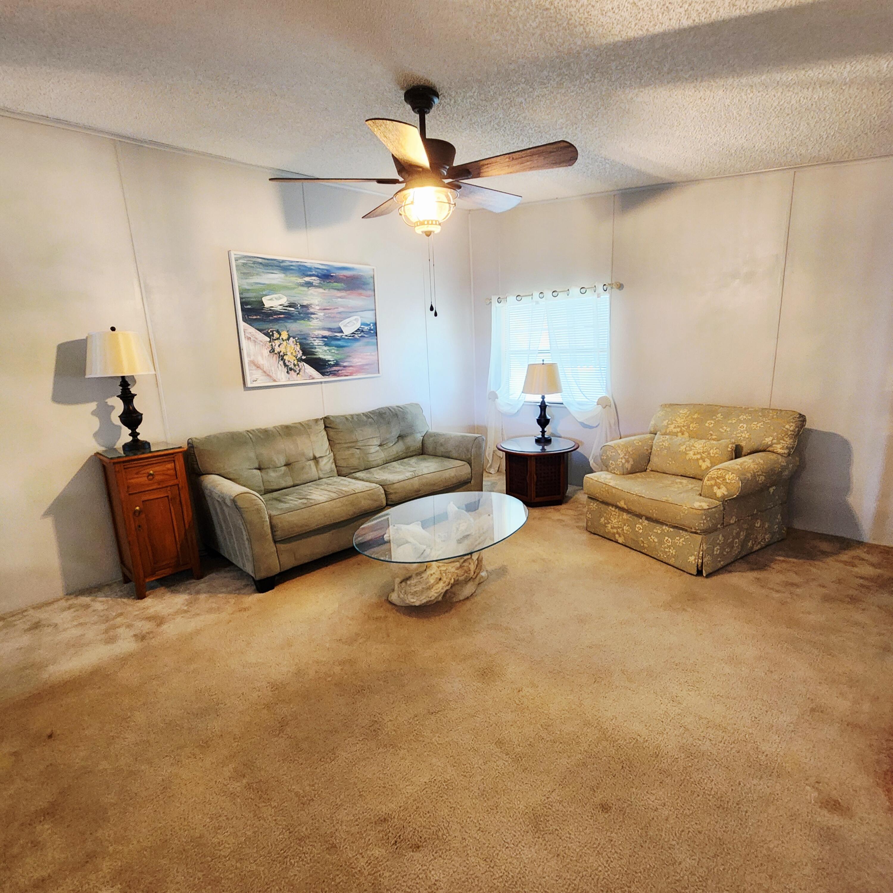 526 Hemingway Terrace, Unit F02 Fort Pierce, FL 34982 - Photo 18 of 55 a living room with furniture and a large window