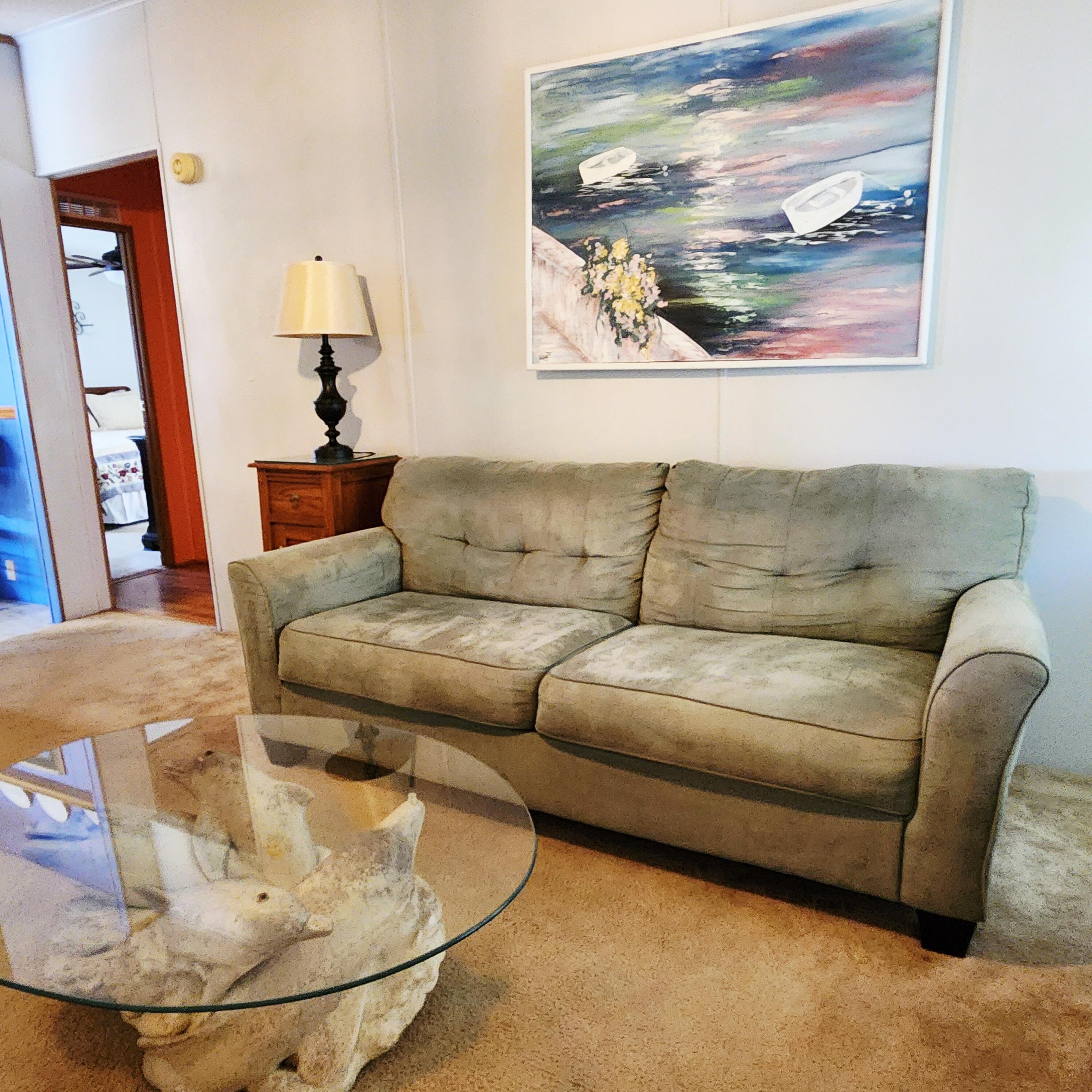 526 Hemingway Terrace, Unit F02 Fort Pierce, FL 34982 - Photo 19 of 55 a living room with furniture and a mirror
