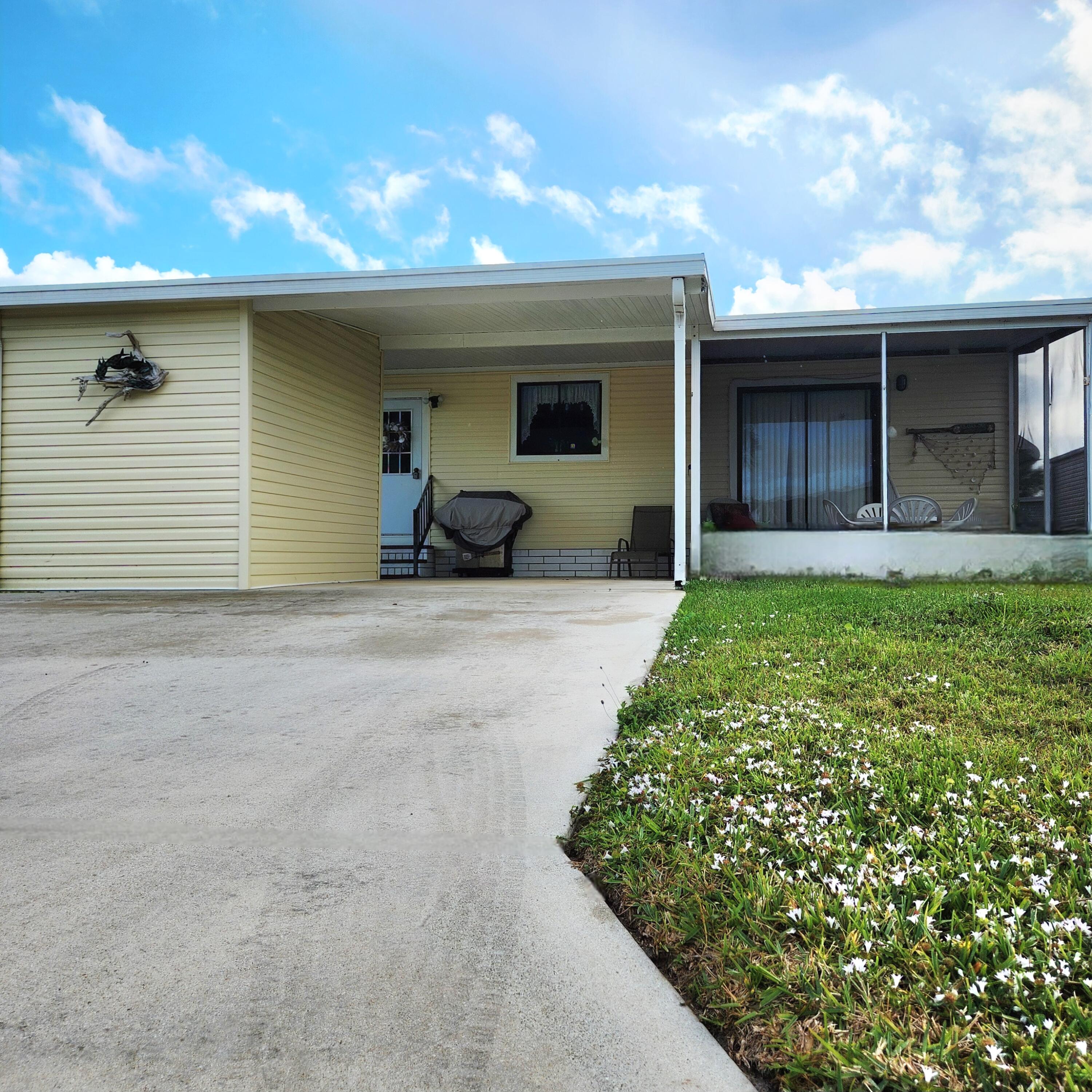 526 Hemingway Terrace, Unit F02 Fort Pierce, FL 34982 - Photo 2 of 55 a view of a house with a patio and a yard