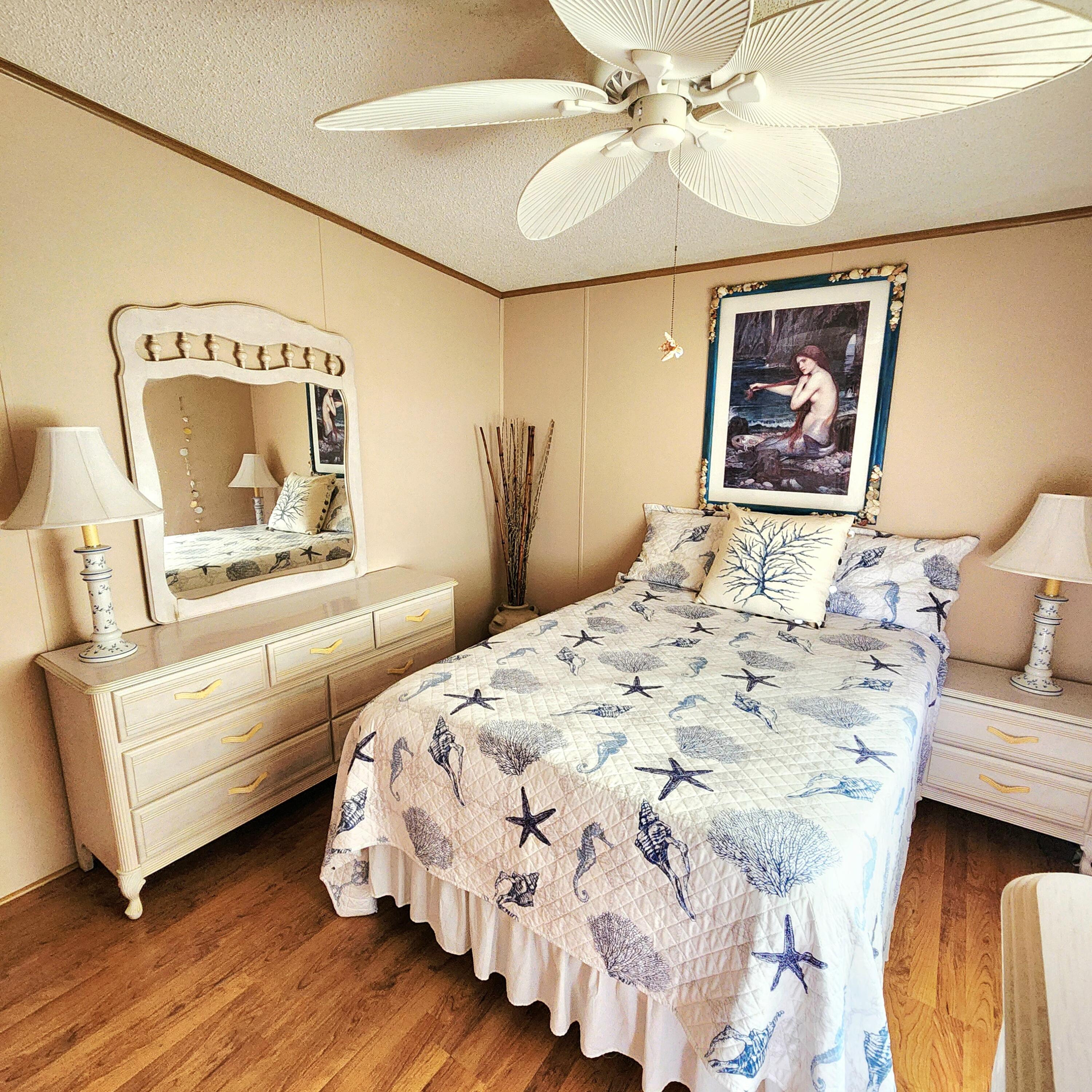526 Hemingway Terrace, Unit F02 Fort Pierce, FL 34982 - Photo 21 of 55 a bedroom with a bed and wooden floor