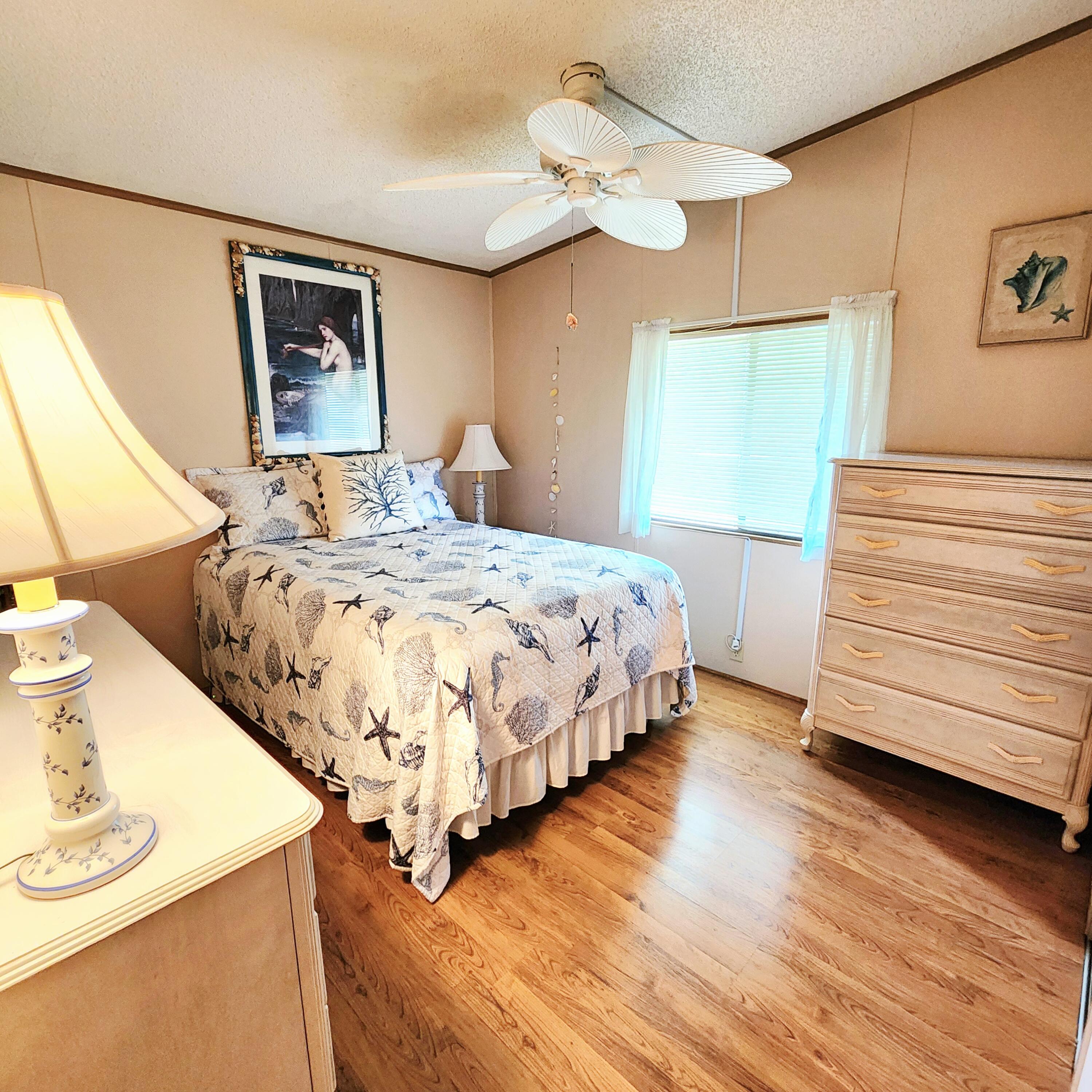 526 Hemingway Terrace, Unit F02 Fort Pierce, FL 34982 - Photo 22 of 55 a bedroom with a bed and a dresser
