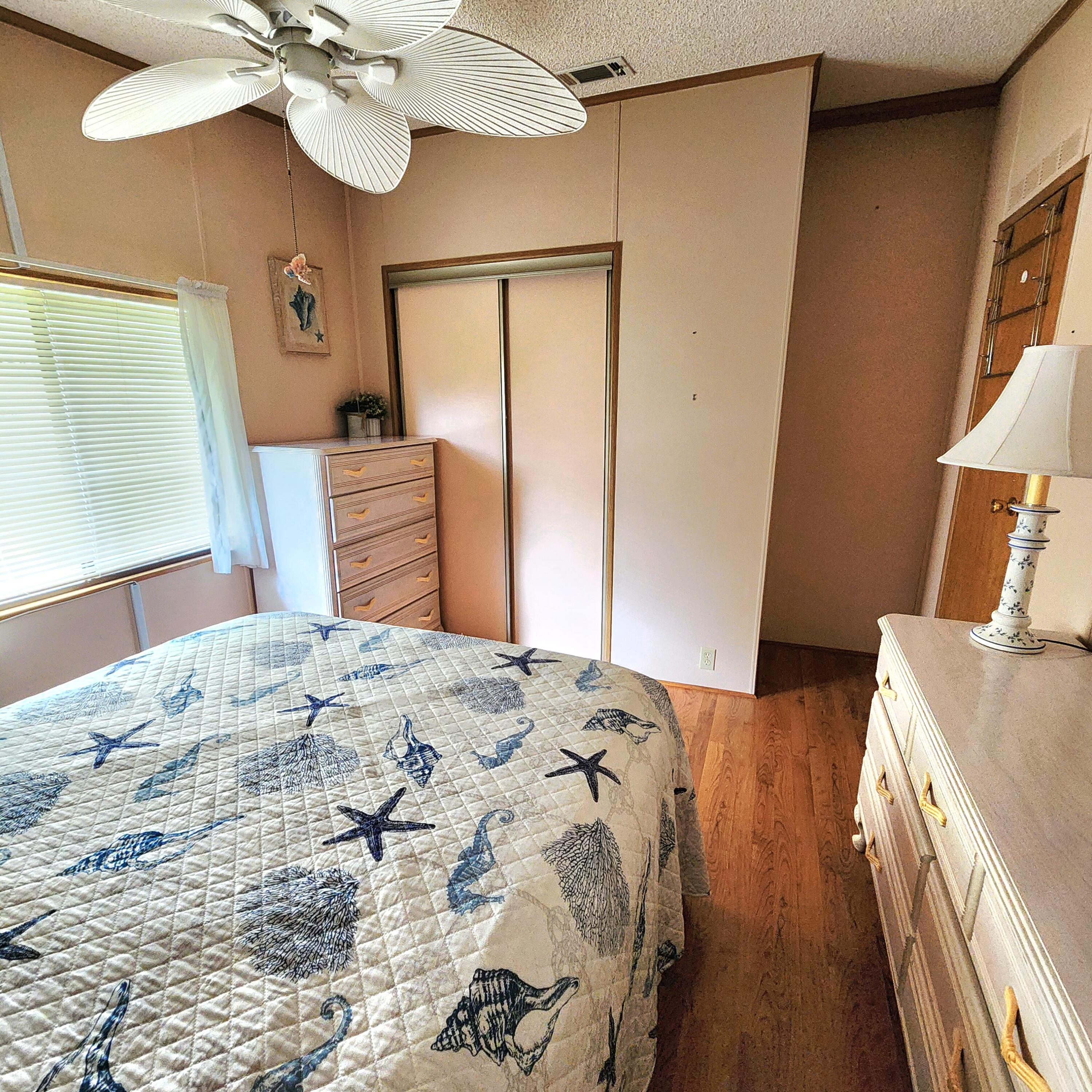 526 Hemingway Terrace, Unit F02 Fort Pierce, FL 34982 - Photo 23 of 55 a bedroom with a bed and a chandelier