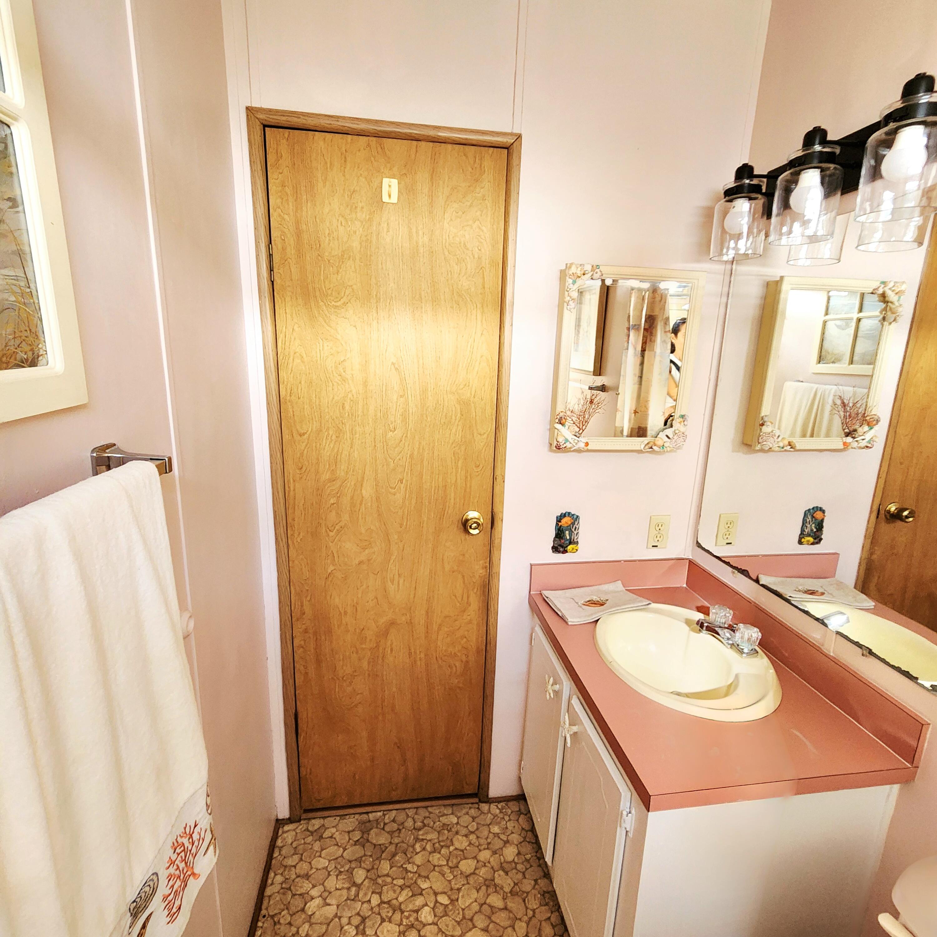 526 Hemingway Terrace, Unit F02 Fort Pierce, FL 34982 - Photo 26 of 55 a bathroom with a sink and a mirror