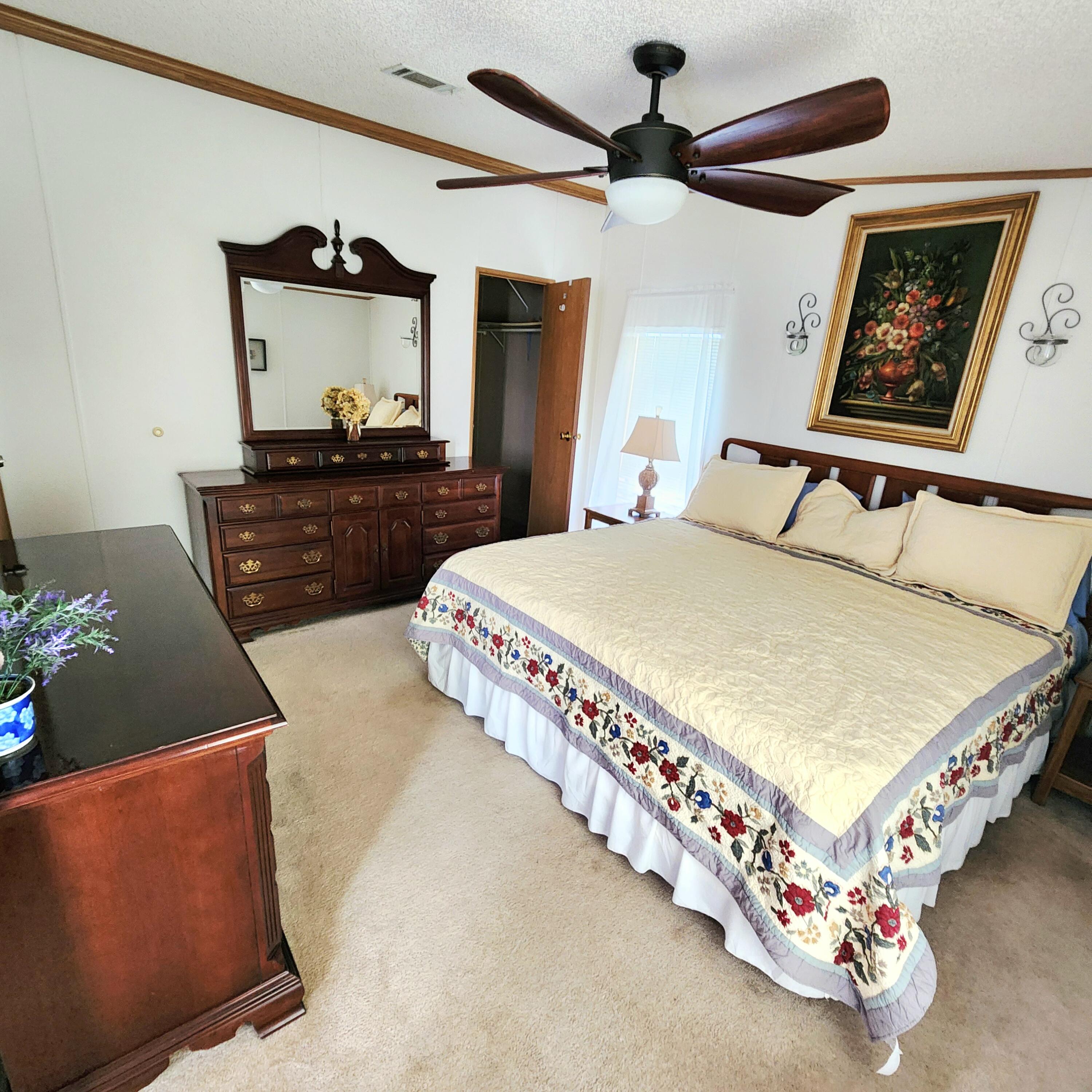 526 Hemingway Terrace, Unit F02 Fort Pierce, FL 34982 - Photo 29 of 55 a bed room with a bed and a dresser