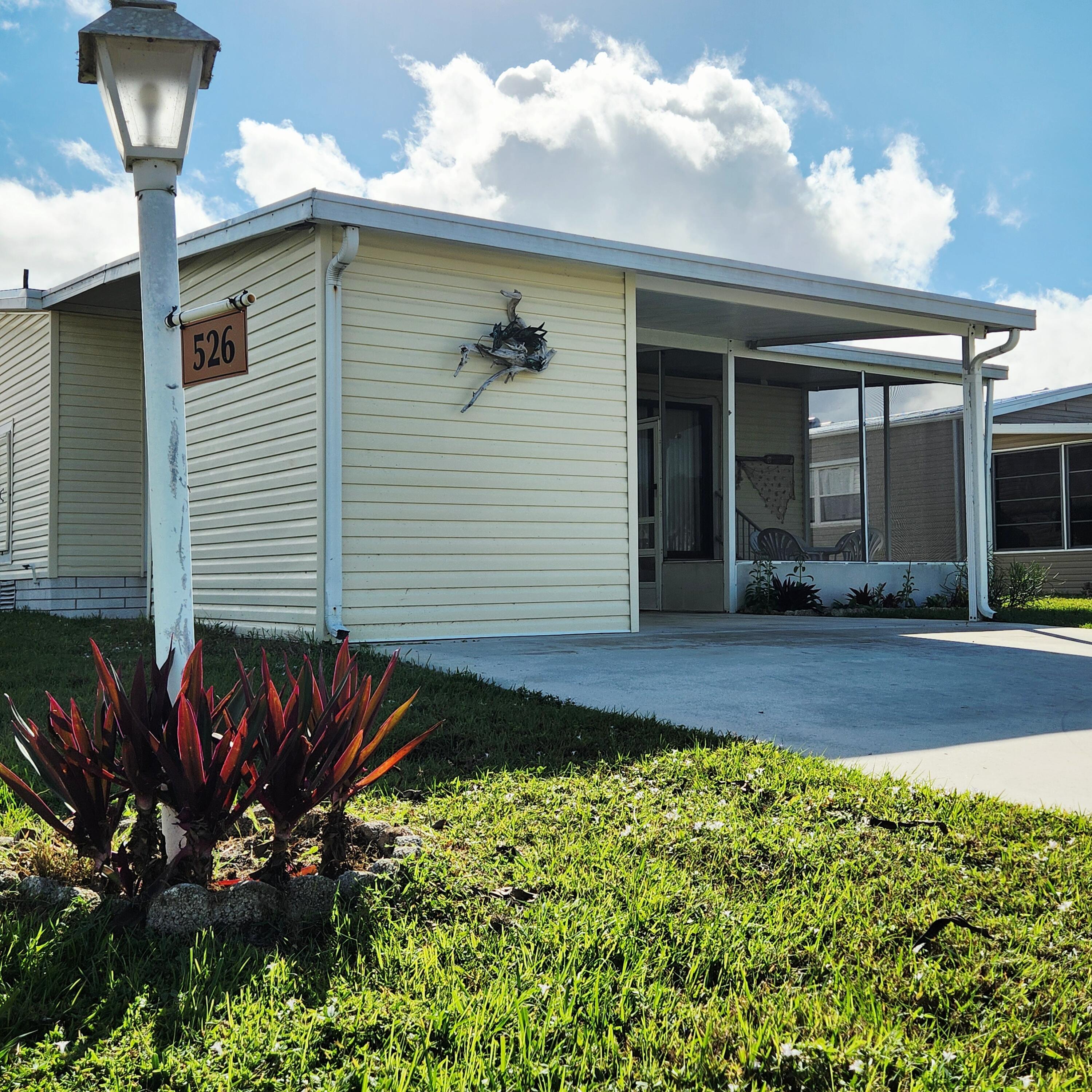 526 Hemingway Terrace, Unit F02 Fort Pierce, FL 34982 - Photo 3 of 55 a front view of a house with a yard