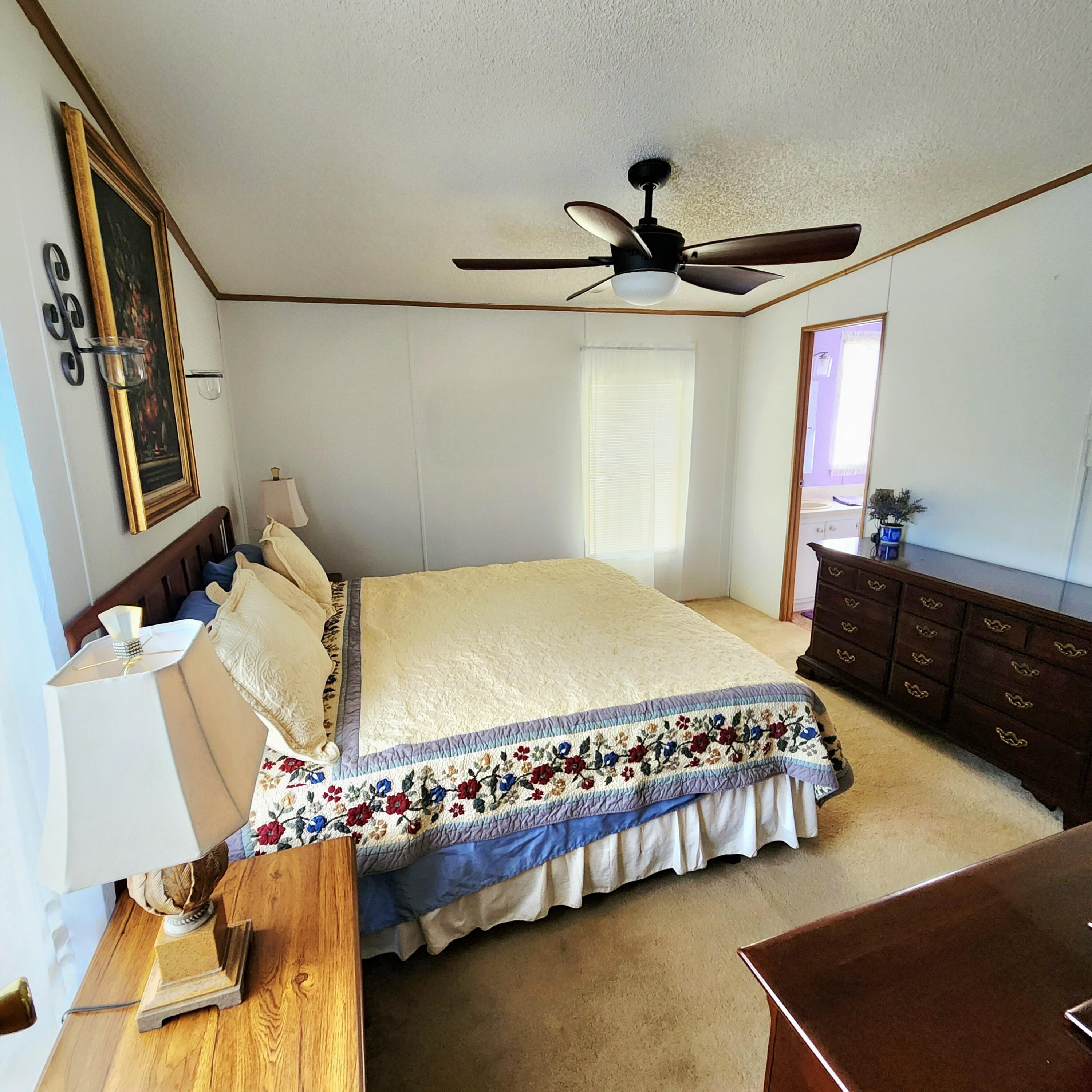 526 Hemingway Terrace, Unit F02 Fort Pierce, FL 34982 - Photo 31 of 55 a bedroom with a bed and a dresser