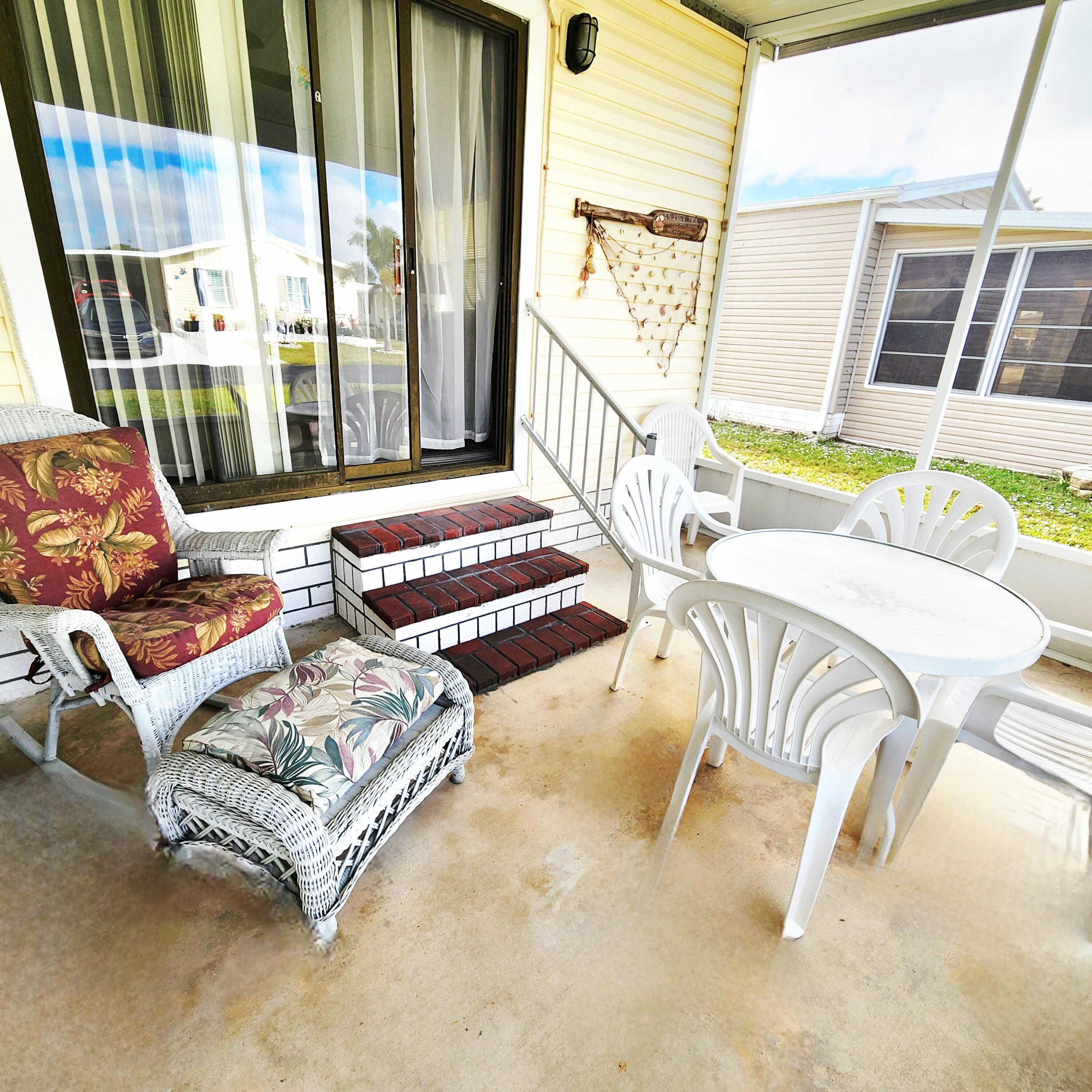 526 Hemingway Terrace, Unit F02 Fort Pierce, FL 34982 - Photo 36 of 55 a living room with furniture and a floor to ceiling window