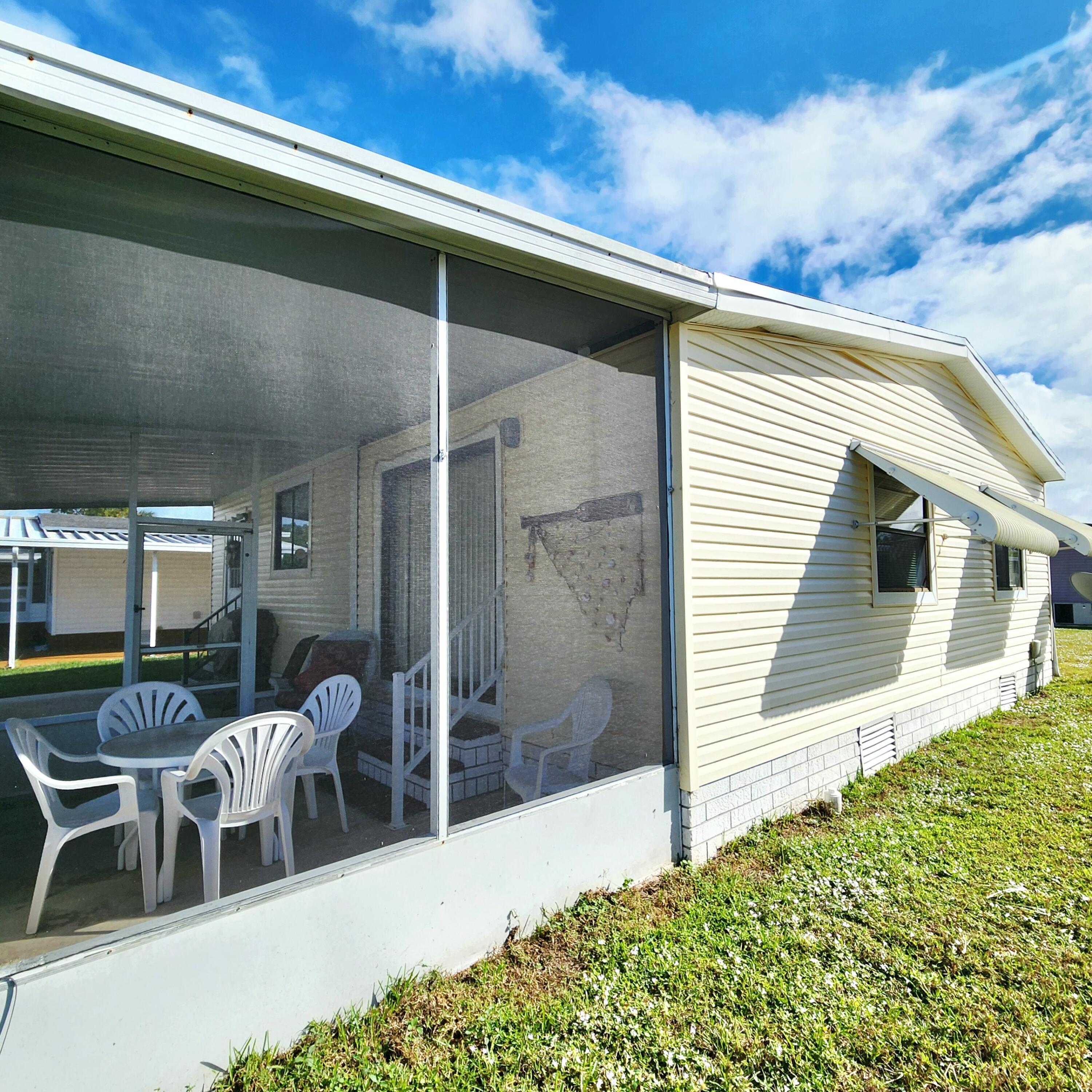 526 Hemingway Terrace, Unit F02 Fort Pierce, FL 34982 - Photo 40 of 55 a view of a patio with table and chairs and potted plants