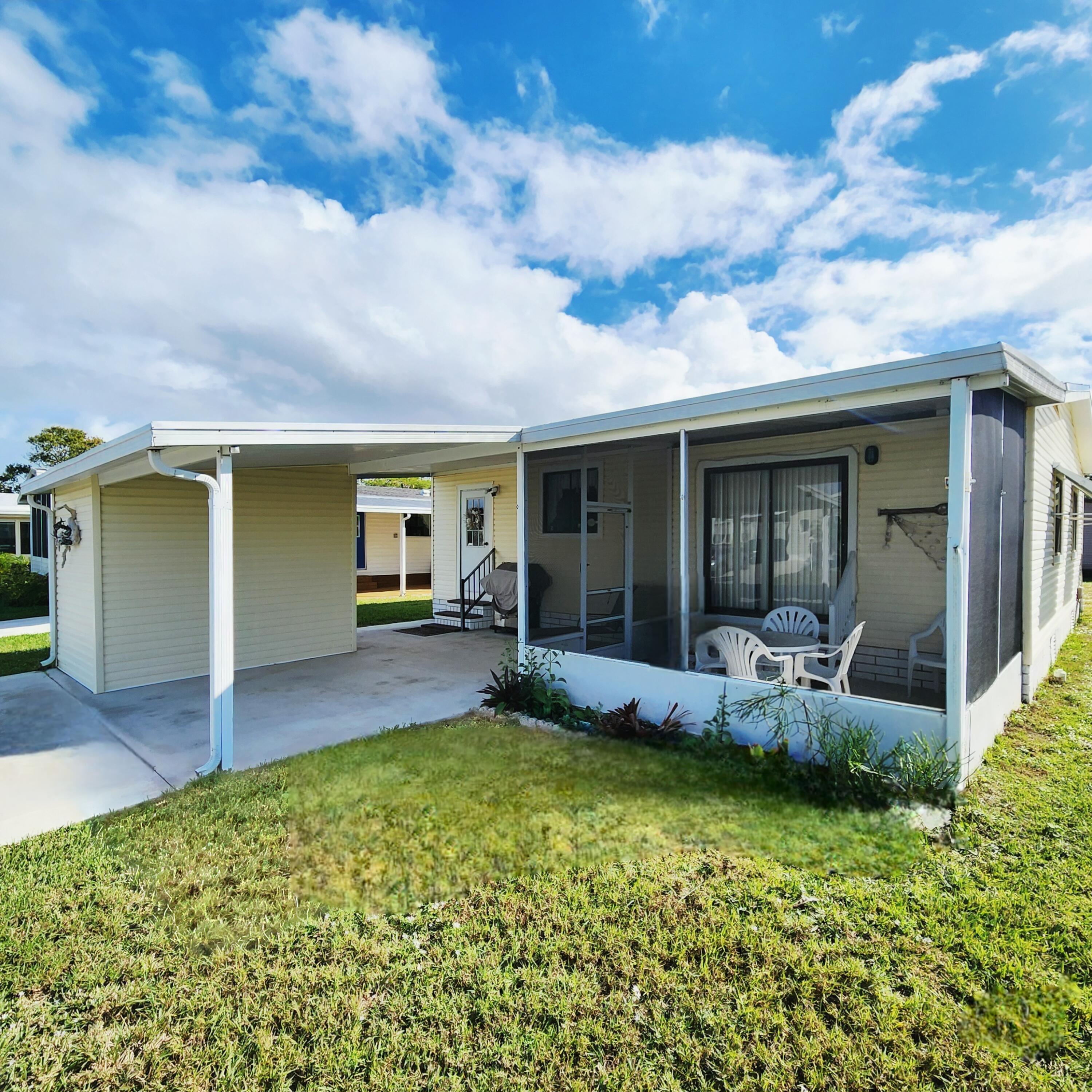 526 Hemingway Terrace, Unit F02 Fort Pierce, FL 34982 - Photo 45 of 55 a view of a house with backyard sitting area and garden
