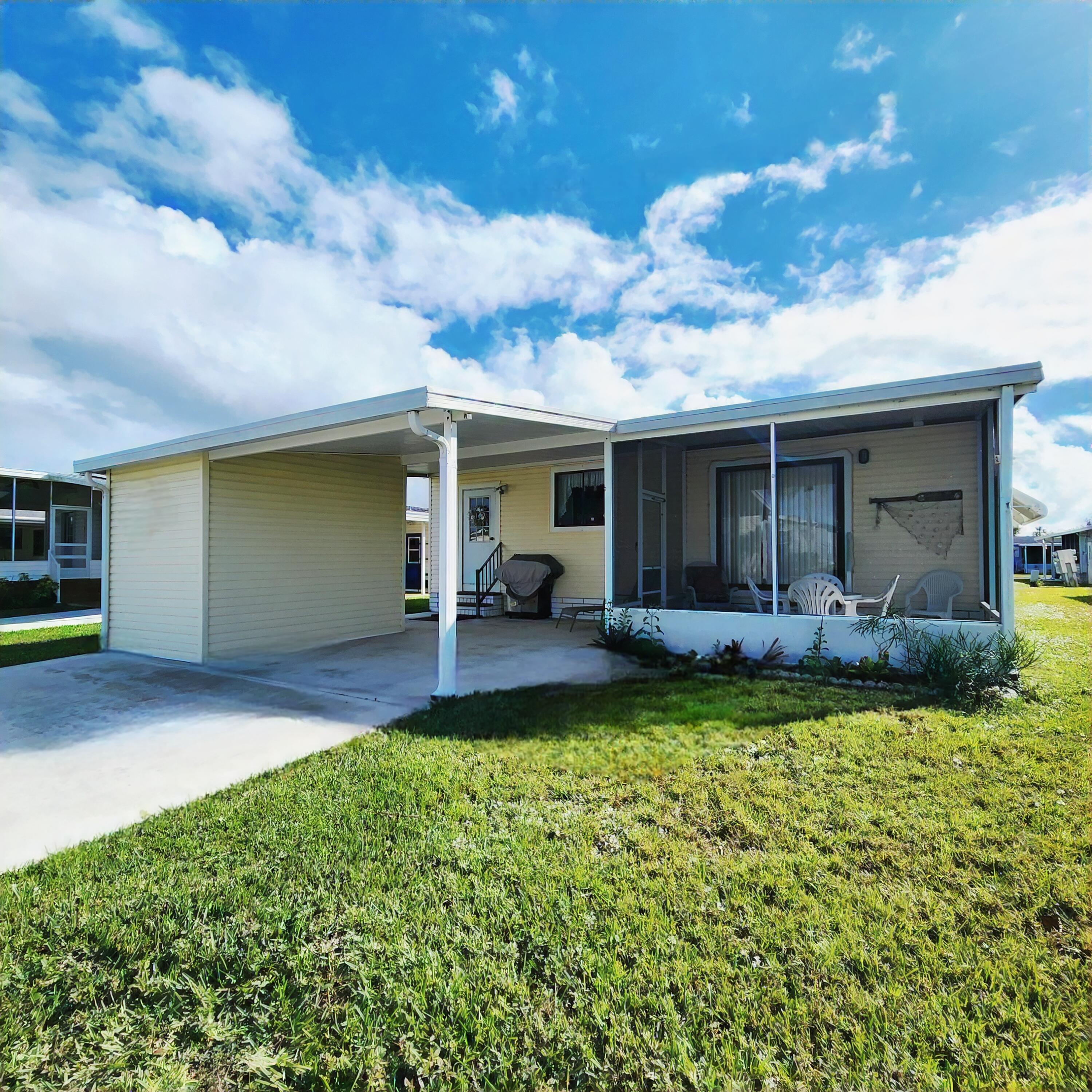 526 Hemingway Terrace, Unit F02 Fort Pierce, FL 34982 - Photo 46 of 55 a view of a house with backyard and porch