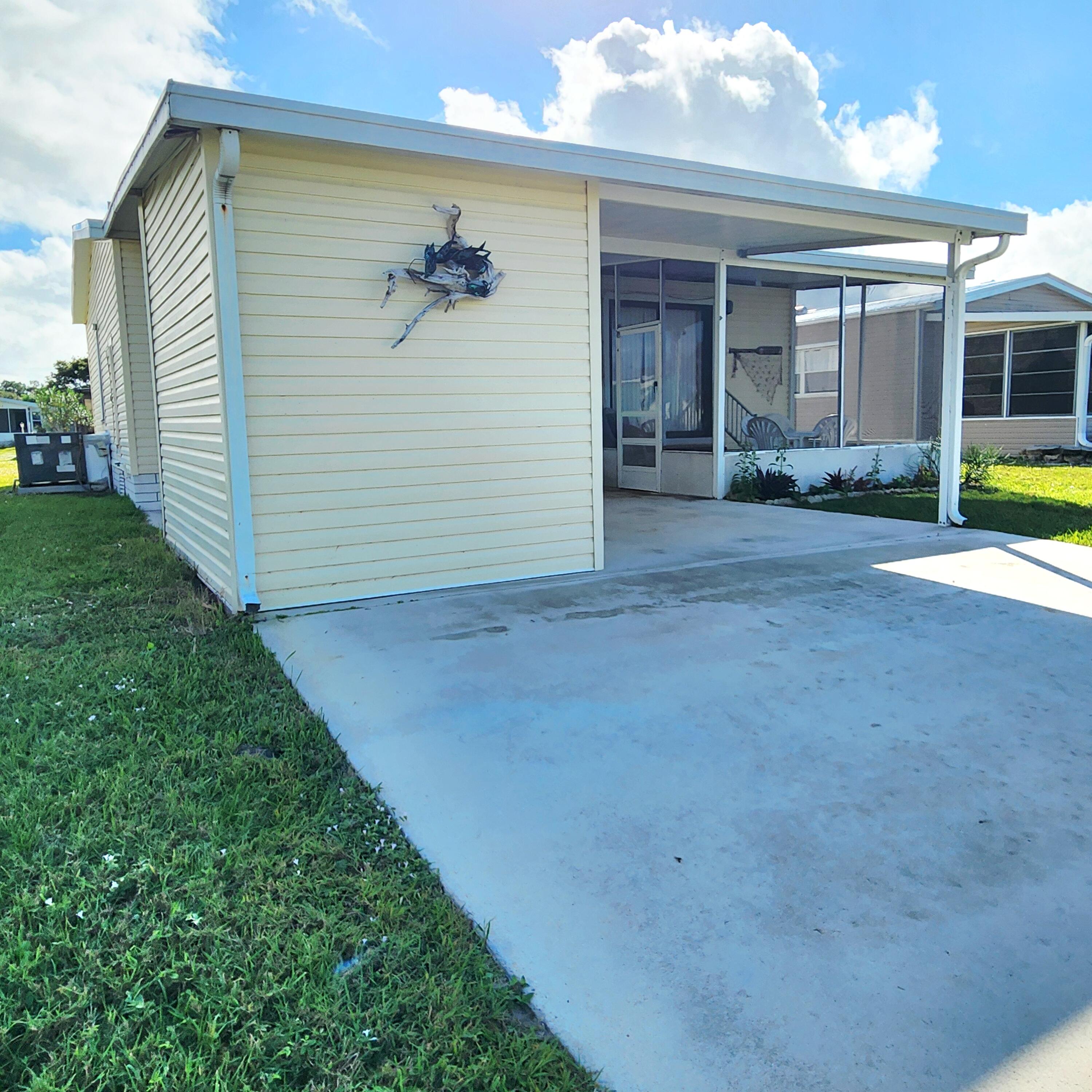 526 Hemingway Terrace, Unit F02 Fort Pierce, FL 34982 - Photo 48 of 55 a view of a house with backyard and porch