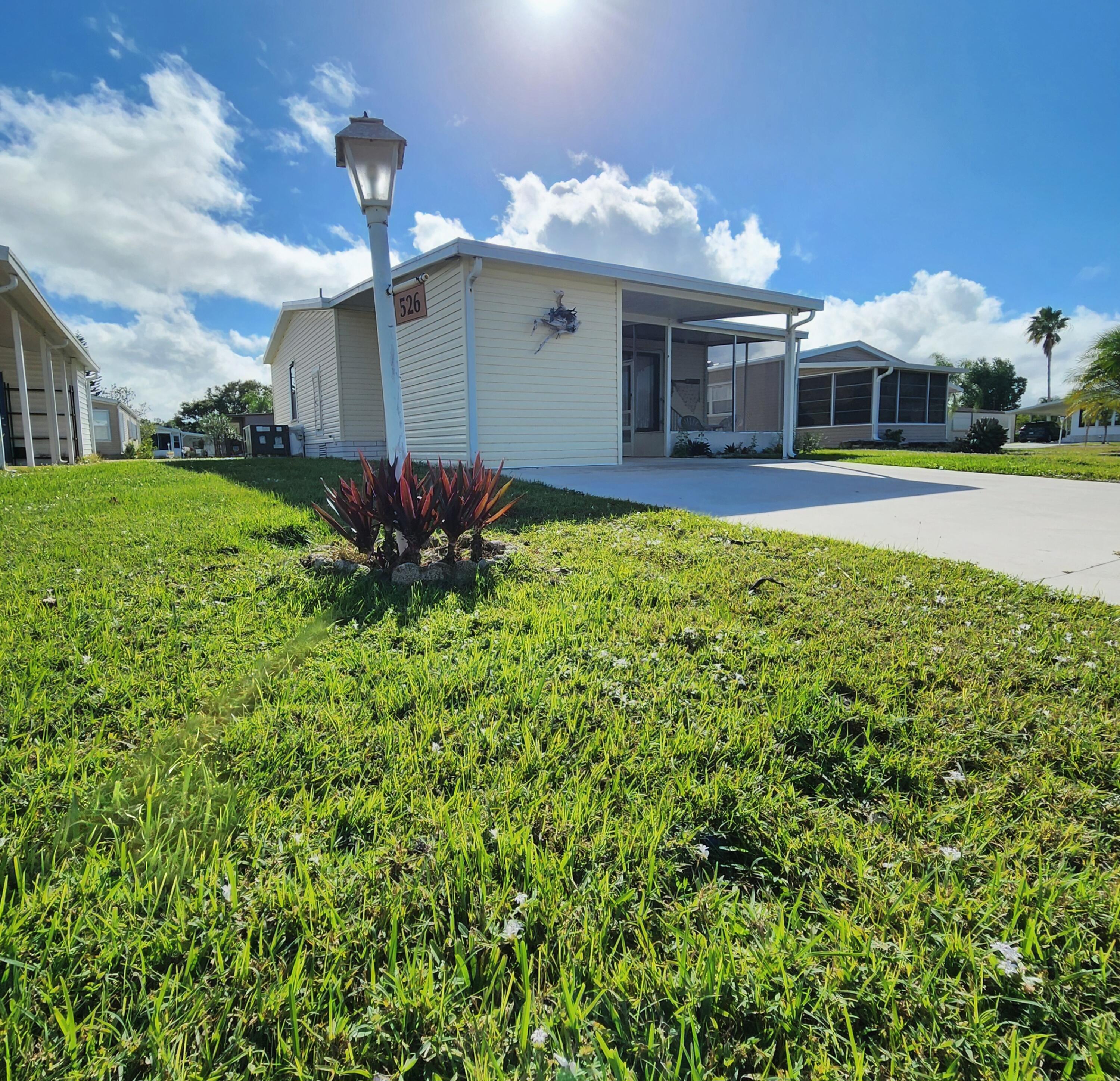 526 Hemingway Terrace, Unit F02 Fort Pierce, FL 34982 - Photo 49 of 55 a view of a house with a yard